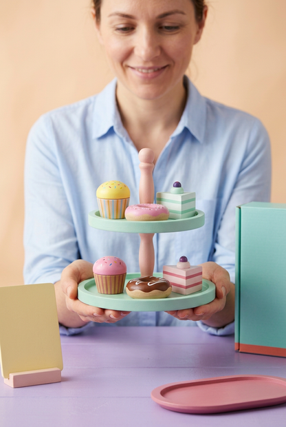 Adult female model holding pretend dessert display stand